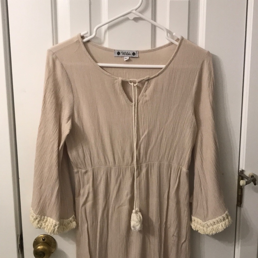 Maxi dress. Light gray to cream color with tassel trim to both arms.